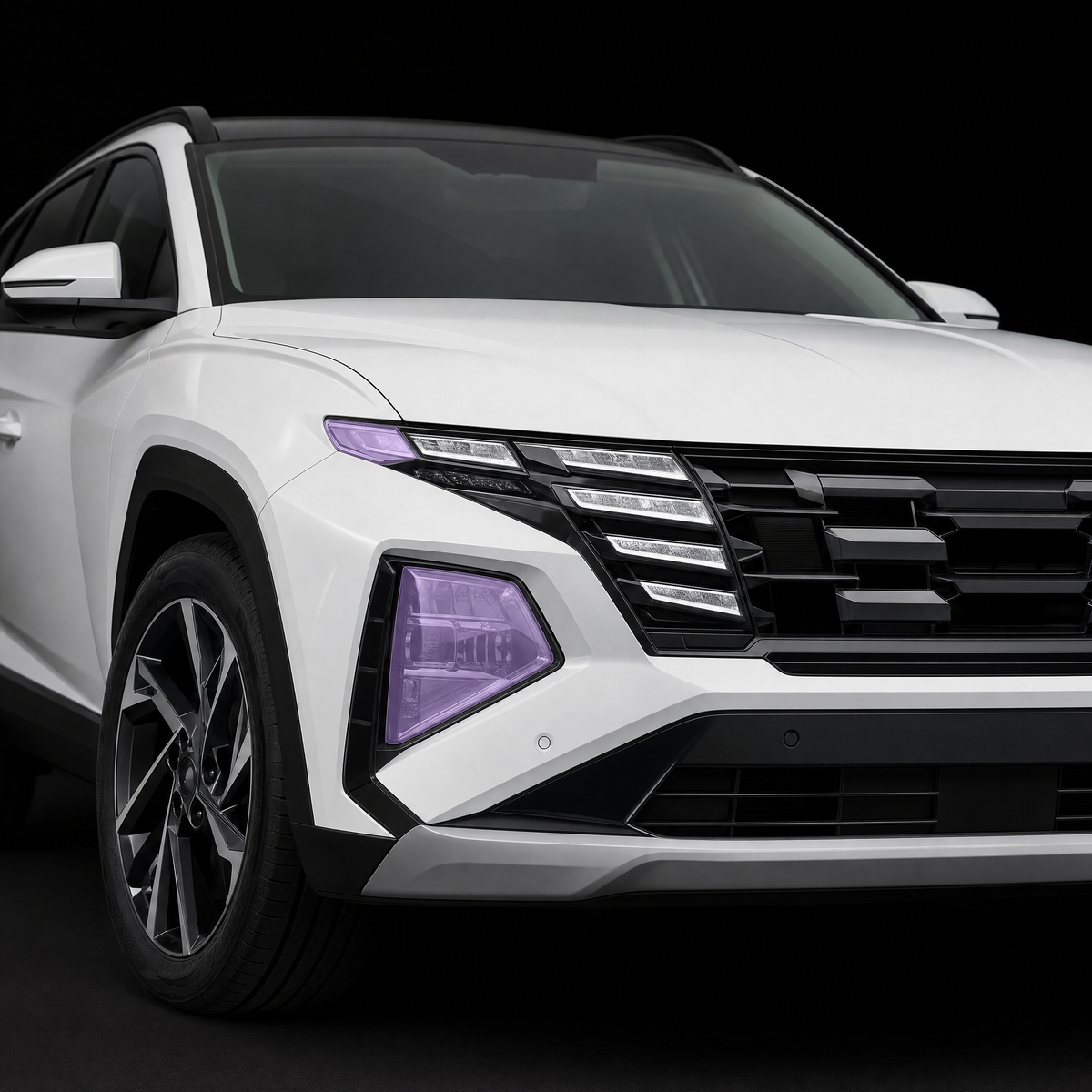 Pre-cut headlight protection film shown tinted lilac on the headlights of a white Hyundai Tucson