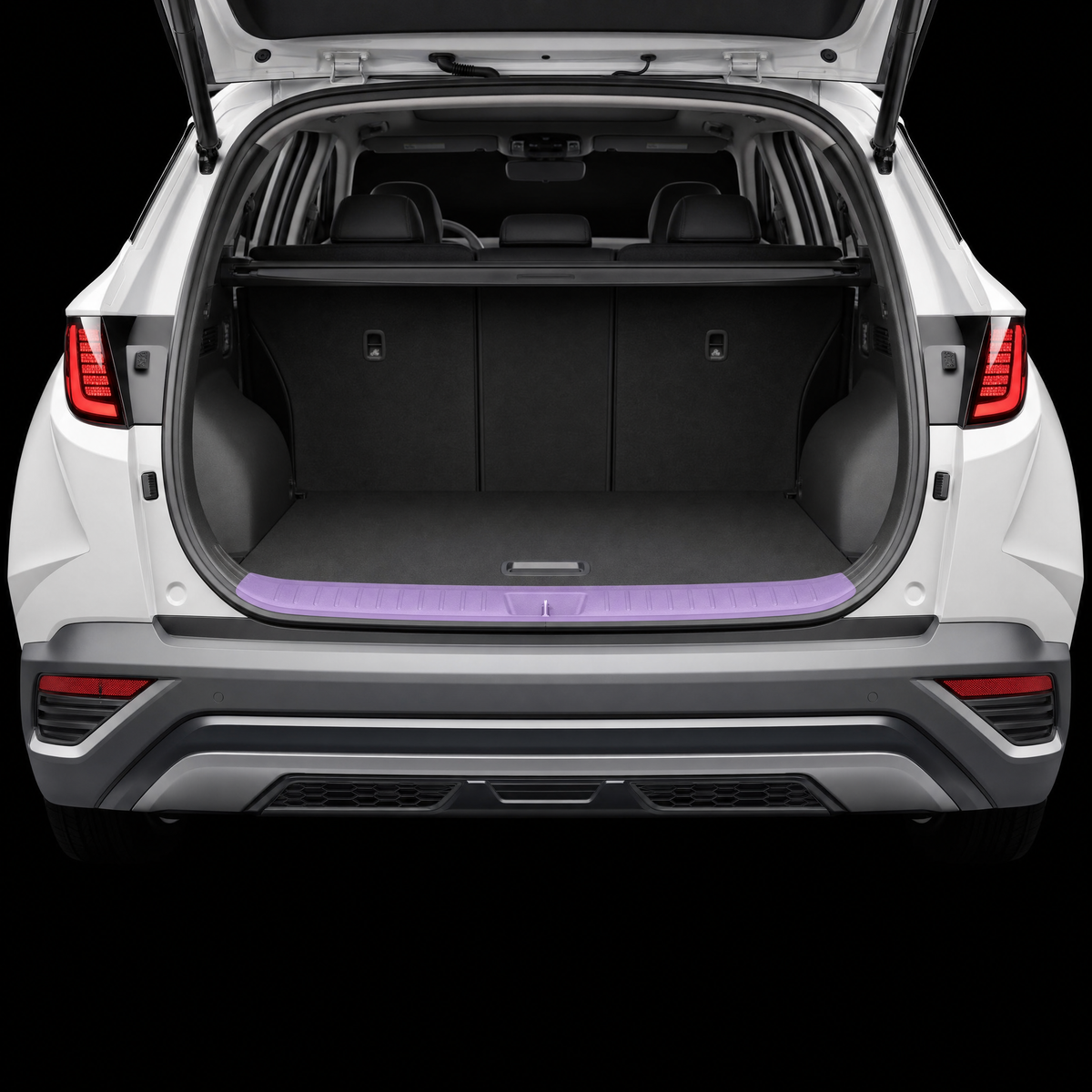 Pre-cut luggage sill protection film shown tinted lilac on the boot loading lip of a white Hyundai Tucson