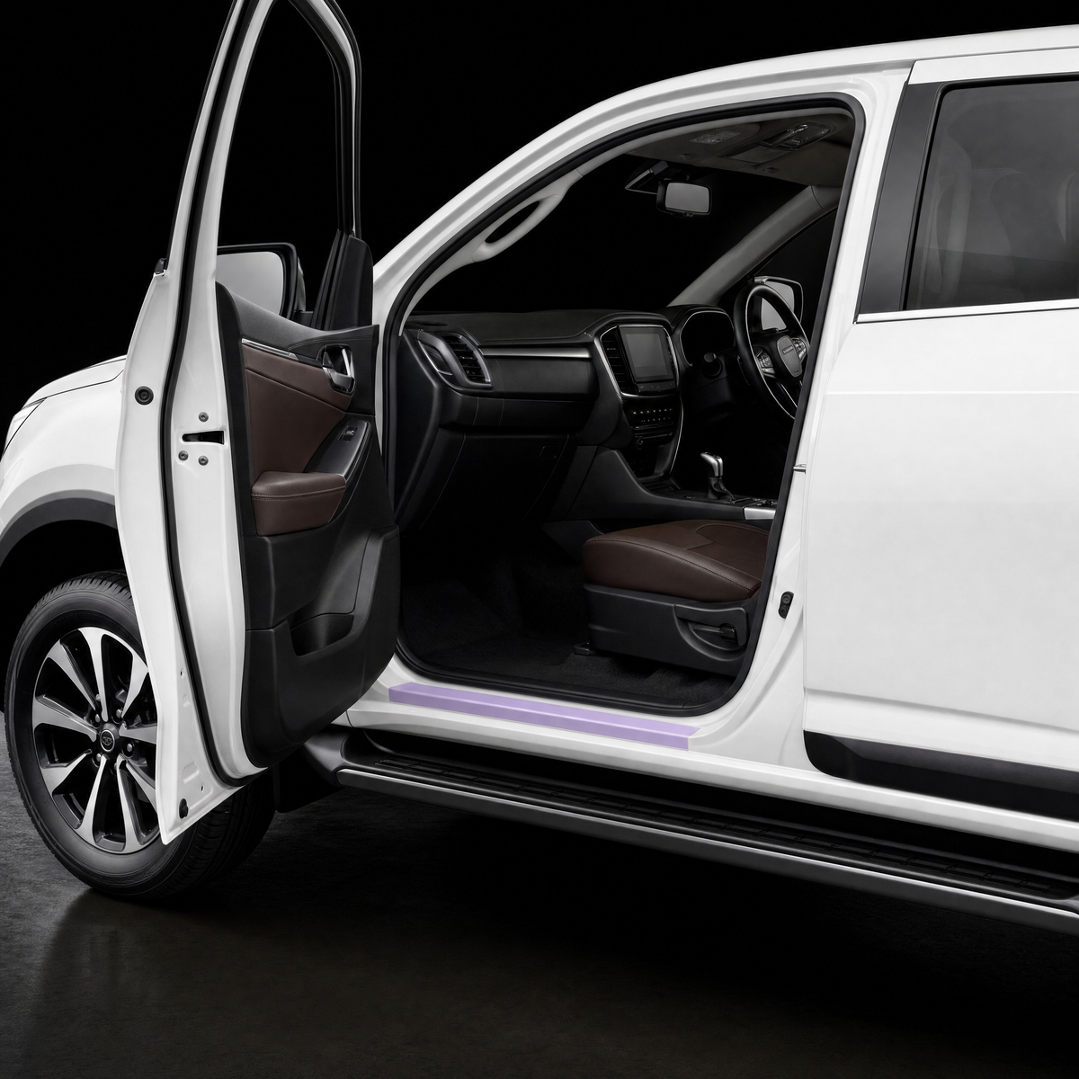 Pre-cut door sill protection film shown tinted lilac on the lower sill of a white Isuzu MU-X
